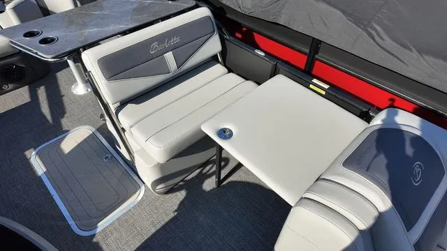Slide: The Image of 2024 Barletta Cabrio C24UE boat interior with gray seating and table. - 28