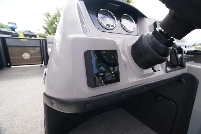 Slide: The Image of The image shows the dashboard of a Barletta Aria A22CC boat with instruments and controls. - 29