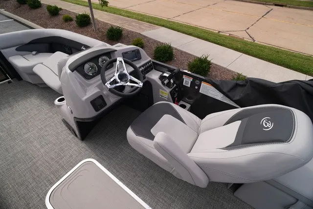 Slide: The Image of The image shows the cockpit of a Barletta Aria A22CC boat with gray seats and a modern helm. - 27