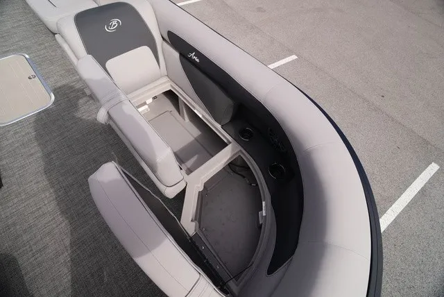 Slide: The Image of The image shows the interior of a Barletta Aria A22CC boat with gray upholstery and storage space. - 39