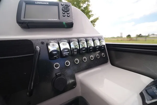 Slide: The Image of The image shows the dashboard of a Barletta Aria A22CC boat with a Lowrance device and multiple switches. - 31