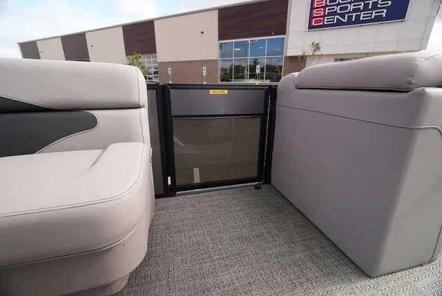 Slide: The Image of The image shows the interior of a Barletta Aria A22CC boat with gray seating. - 25