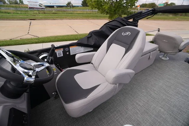 Slide: The Image of The image shows the interior of a Barletta Aria A22CC boat with a cushioned seat. - 33