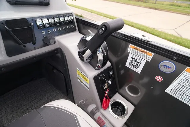 Slide: The Image of Control console of a Barletta Aria A22CC boat with throttle and controls. - 32
