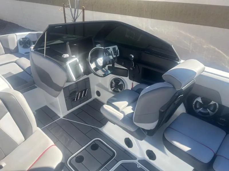 Slide: The Image of 2021 Malibu 23 MXZ boat interior with modern dashboard and seating. - 12