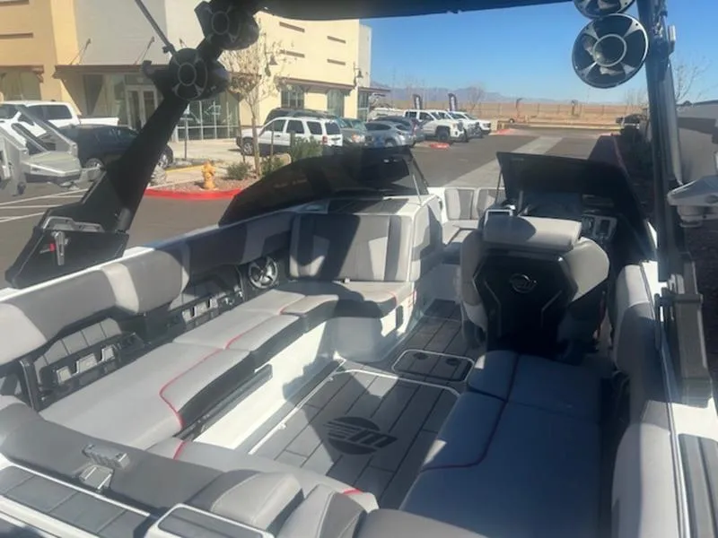 Slide: The Image of 2021 Malibu 23 MXZ boat interior with modern seating and audio system. - 13