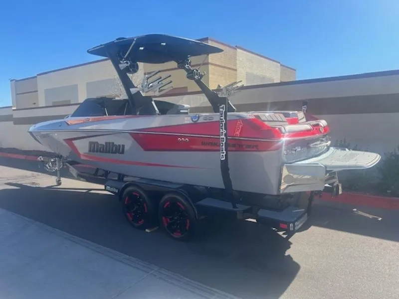 Slide: The Image of 2021 Malibu 23 MXZ boat on trailer, sleek design, red and gray color scheme. - 4