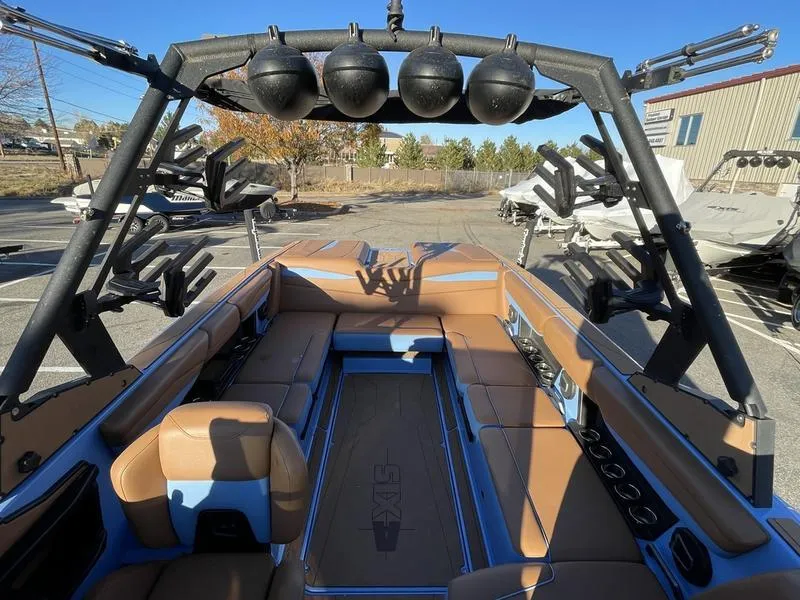 Slide: The Image of 2024 Axis A245 boat interior with tan seating and black wakeboard tower. - 12