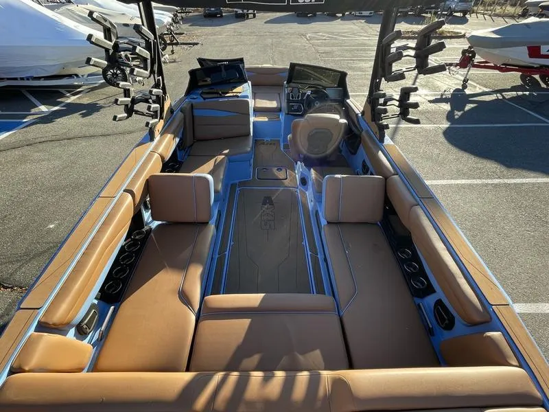 Slide: The Image of 2024 Axis A245 boat interior with tan seating and modern dashboard. - 15
