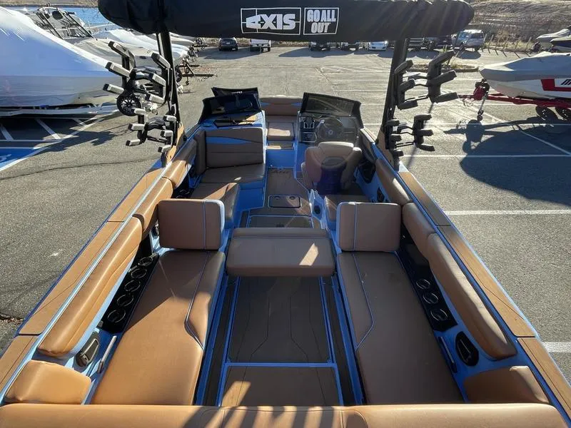 Slide: The Image of 2024 Axis A245 boat interior with tan seating and advanced dashboard features. - 16