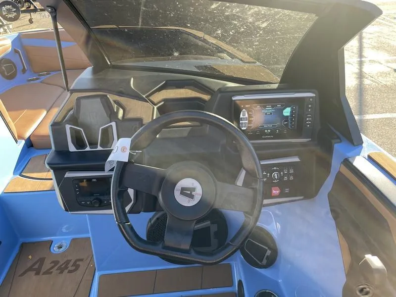 Slide: The Image of 2024 Axis A245 boat dashboard with steering wheel and digital display. - 8