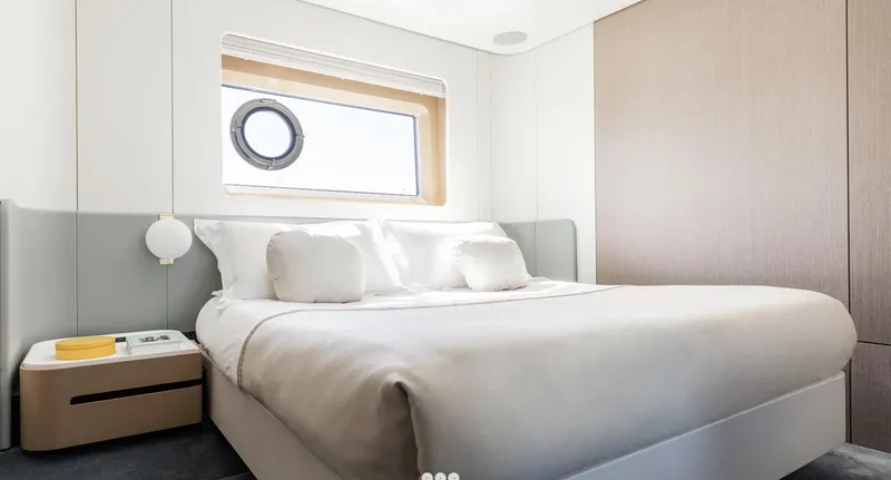 Slide: The Image of Luxurious bedroom in 2025 Azimut Grande 26M yacht with modern design and porthole window. - 20