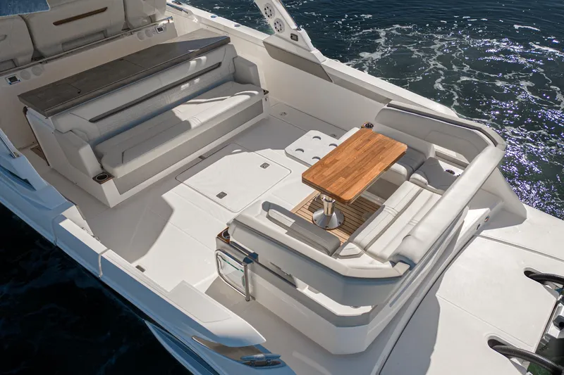 Slide: The Image of 2023 Tiara Yachts 43 LS boat interior with seating and wooden table. - 11