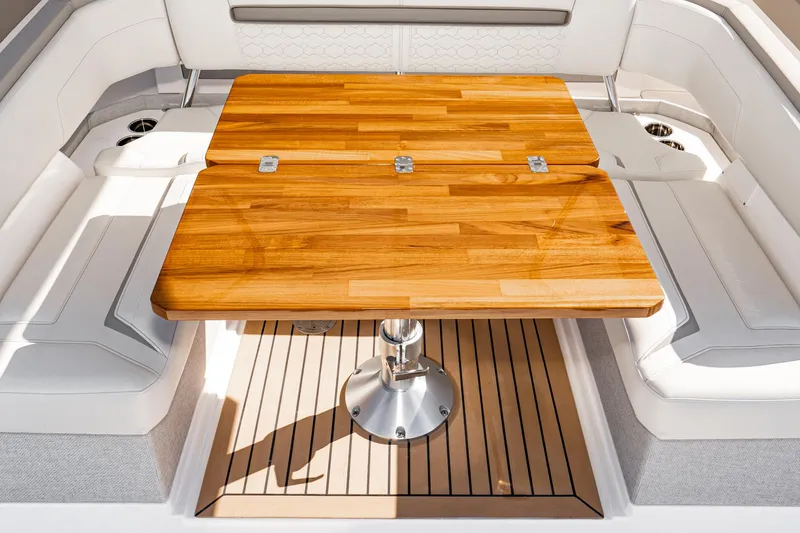 Slide: The Image of 2023 Tiara Yachts 43 LS interior with wooden table and cushioned seating. - 14
