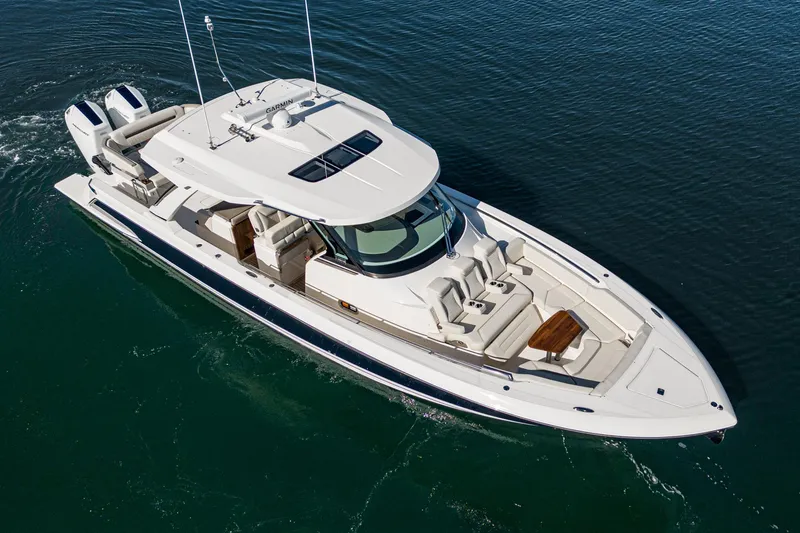 Slide: The Image of 2023 Tiara Yachts 43 LS cruising on open water, aerial view. - 2