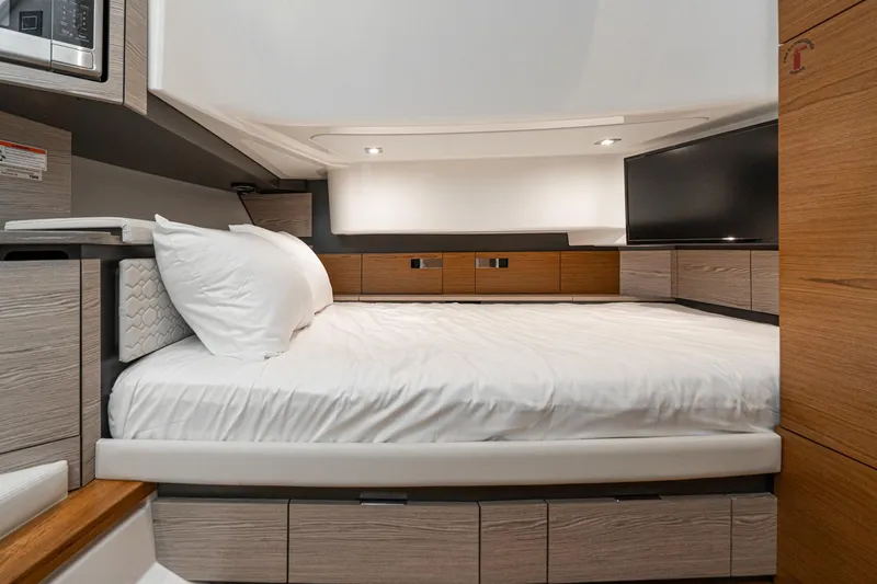 Slide: The Image of Luxurious cabin interior of 2023 Tiara Yachts 43 LS with modern design and cozy bedding. - 33