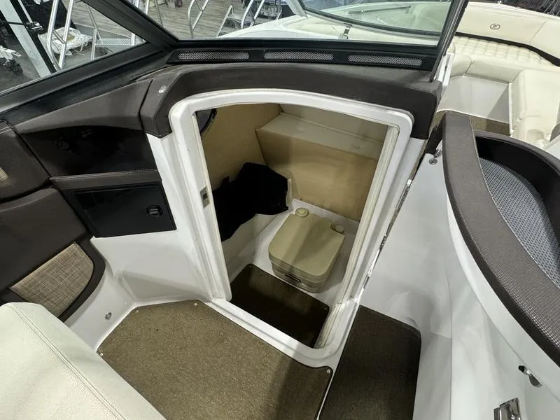 Slide: The Image of 2017 Cobalt R7WSS Surf boat interior with compact cabin and portable toilet. - 13