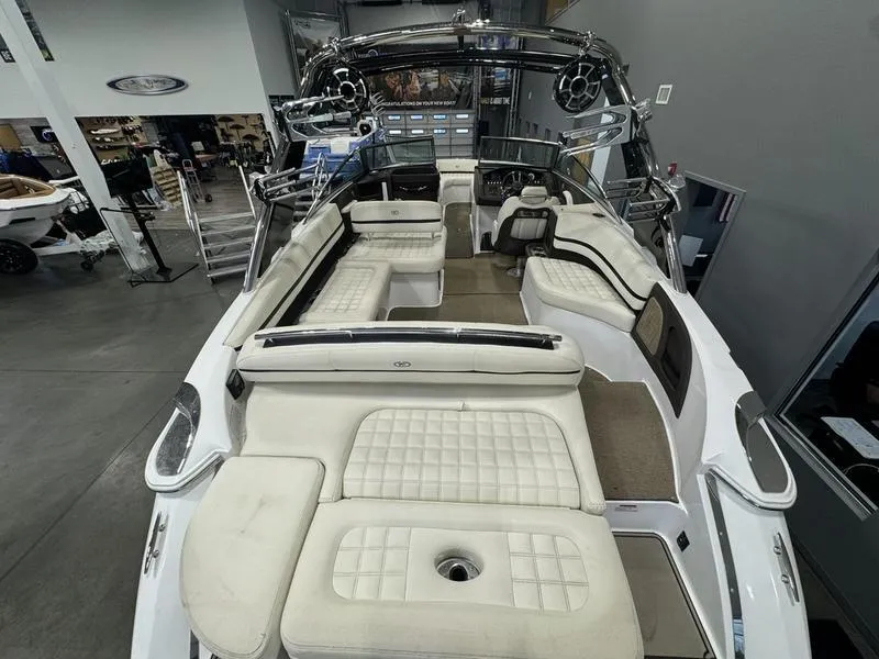 Slide: The Image of 2017 Cobalt R7WSS Surf boat with spacious white seating in showroom. - 6