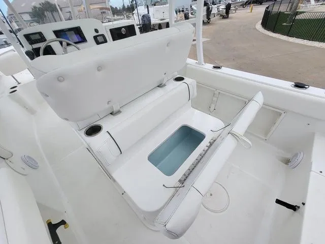 Slide: The Image of 2016 Sea Hunt Edge 24 boat interior with open storage compartment and seating. - 11