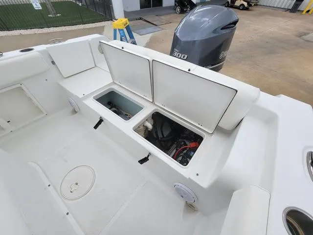 Slide: The Image of 2016 Sea Hunt Edge 24 boat interior with open storage compartments and Yamaha 300 outboard motor. - 12