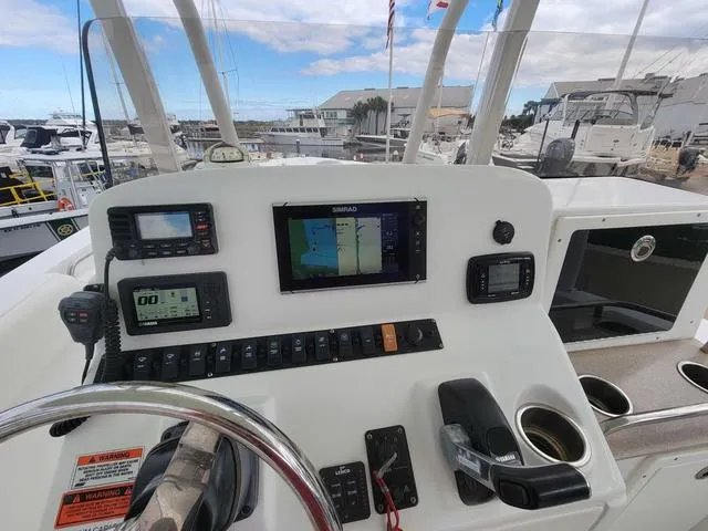 Slide: The Image of 2016 Sea Hunt Edge 24 boat dashboard with navigation and control systems. - 13