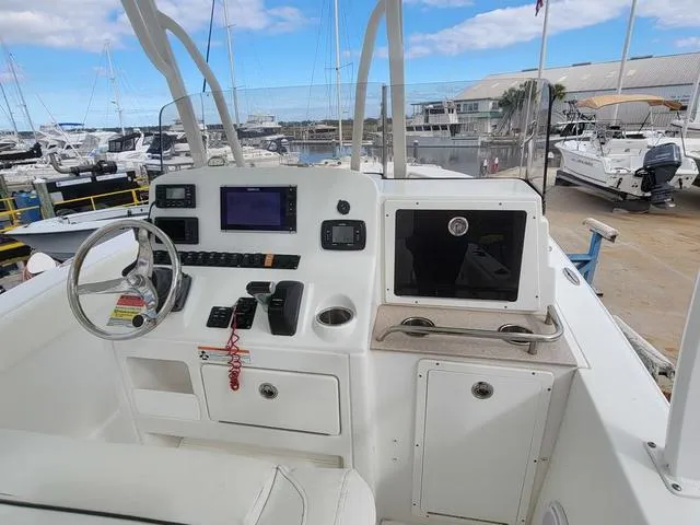 Slide: The Image of 2016 Sea Hunt Edge 24 boat dashboard with navigation equipment at marina. - 16