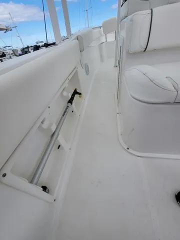 Slide: The Image of 2016 Sea Hunt Edge 24 boat interior with white seating and storage compartment. - 17