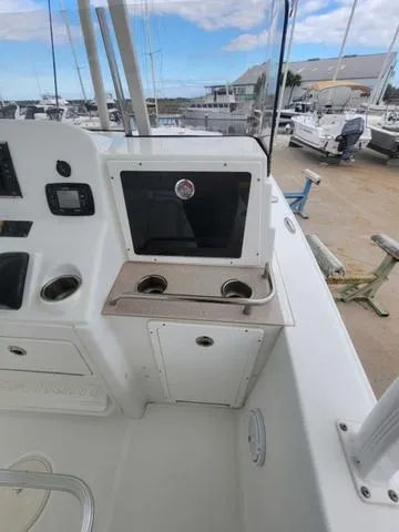 Slide: The Image of 2016 Sea Hunt Edge 24 boat interior with control panel and storage. - 19