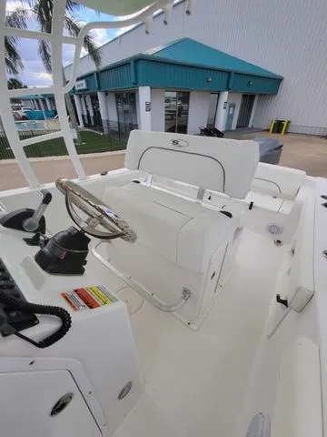 Slide: The Image of 2016 Sea Hunt Edge 24 boat interior with steering wheel and seating. - 20