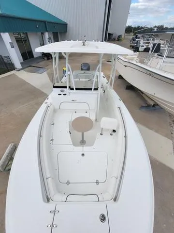 Slide: The Image of 2016 Sea Hunt Edge 24 boat, white deck, docked at marina. - 21