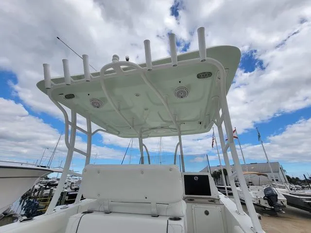 Slide: The Image of 2016 Sea Hunt Edge 24 boat with T-top, docked under cloudy sky. - 25
