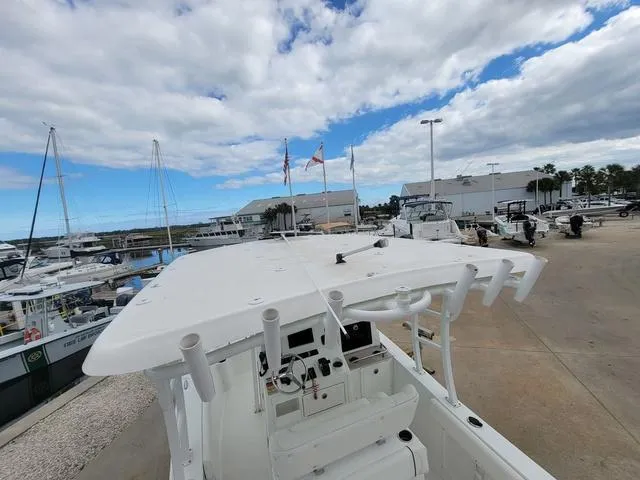 Slide: The Image of 2016 Sea Hunt Edge 24 boat docked at marina under cloudy sky. - 26