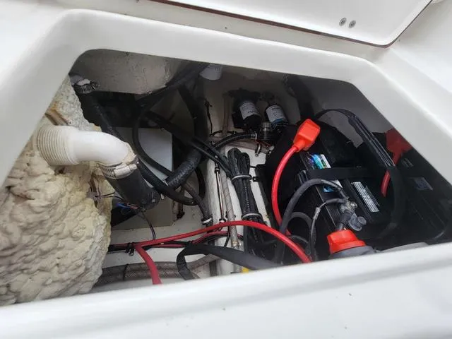 Slide: The Image of 2016 Sea Hunt Edge 24 boat battery compartment with wiring and components. - 27