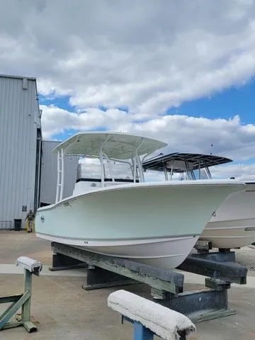 Slide: The Image of 2016 Sea Hunt Edge 24 boat on display at a marina under cloudy skies. - 3