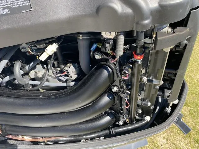 Slide: The Image of Engine components of a 2016 Sea Hunt Edge 24 boat, showcasing intricate wiring and tubing. - 31