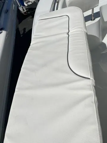 Slide: The Image of 2016 Sea Hunt Edge 24 boat with white cushioned seating. - 40