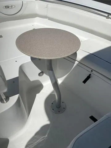 Slide: The Image of 2016 Sea Hunt Edge 24 boat interior with a small round table. - 41