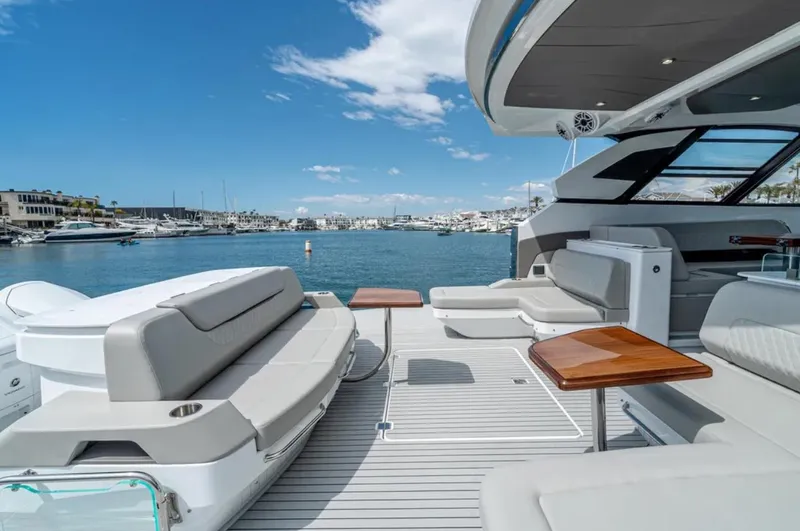 Slide: The Image of Luxurious 2025 Cruisers Yachts 50 GLS with spacious deck and scenic marina view. - 14
