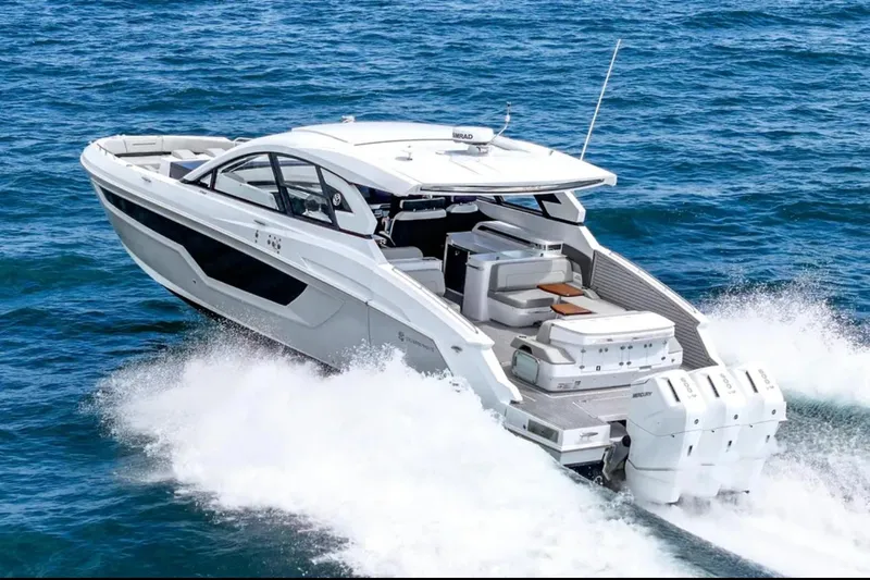 Slide: The Image of 2025 Cruisers Yachts 50 GLS speeding on ocean waters, showcasing luxury and performance. - 2