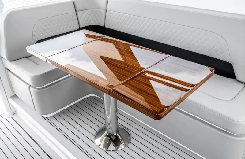 Slide: The Image of Luxurious seating area with wooden table on 2025 Cruisers Yachts 50 GLS. - 22