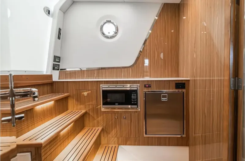 Slide: The Image of Luxurious interior of 2025 Cruisers Yachts 50 GLS with wood paneling and modern appliances. - 31