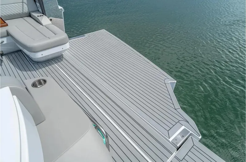 Slide: The Image of 2025 Cruisers Yachts 50 GLS swim platform with seating, on calm water. - 19