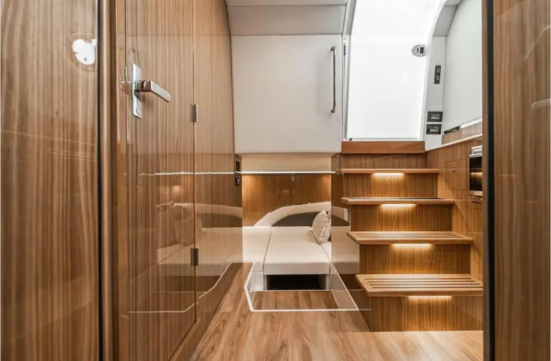 Slide: The Image of Luxurious interior of 2025 Cruisers Yachts 50 GLS with wooden finishes and modern lighting. - 41