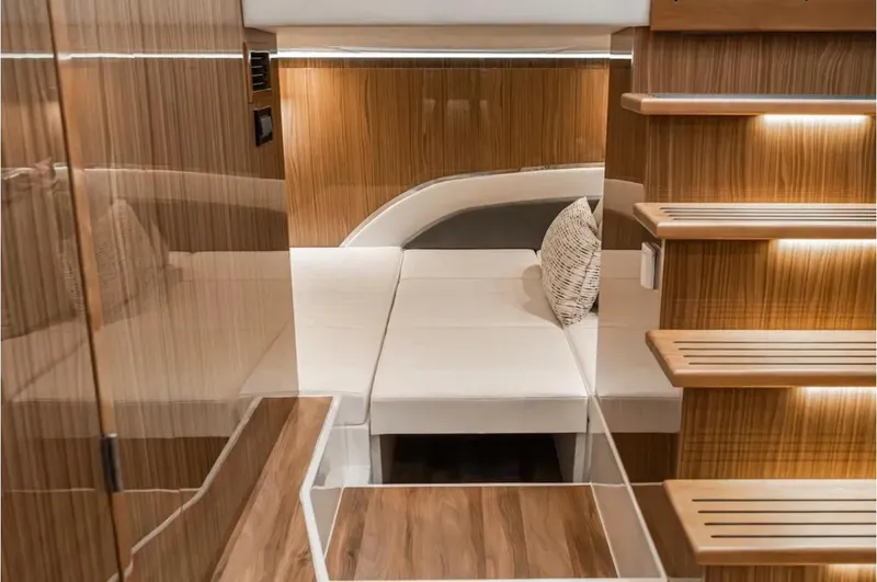 Slide: The Image of Luxurious interior of 2025 Cruisers Yachts 50 GLS with modern wood finishes and cozy seating. - 42