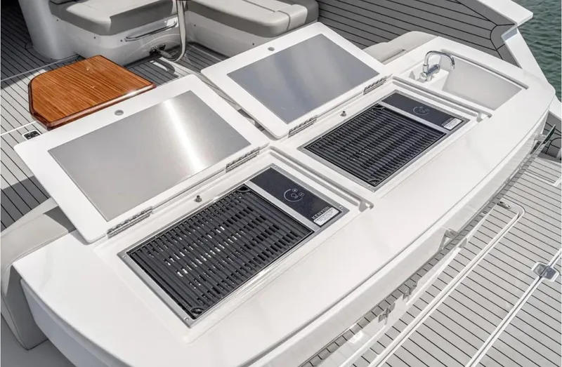 Slide: The Image of Outdoor kitchen on 2025 Cruisers Yachts 50 GLS with grills and sink. - 12