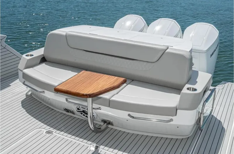 Slide: The Image of 2025 Cruisers Yachts 50 GLS with sleek seating and wooden table on deck. - 15