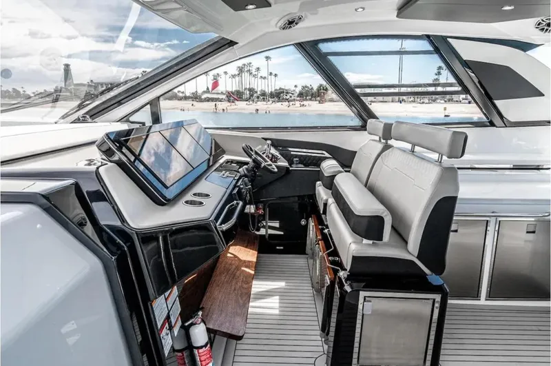 Slide: The Image of 2025 Cruisers Yachts 50 GLS helm with modern controls and panoramic windows. - 26