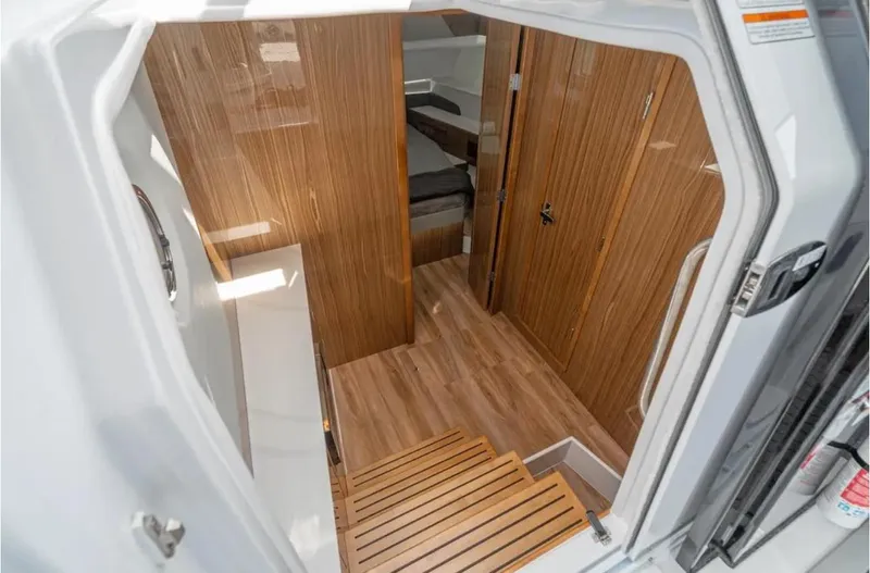 Slide: The Image of Interior of 2025 Cruisers Yachts 50 GLS with wood paneling and modern design. - 29