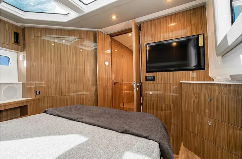 Slide: The Image of Luxurious 2025 Cruisers Yachts 50 GLS cabin interior with wood paneling and modern amenities. - 35