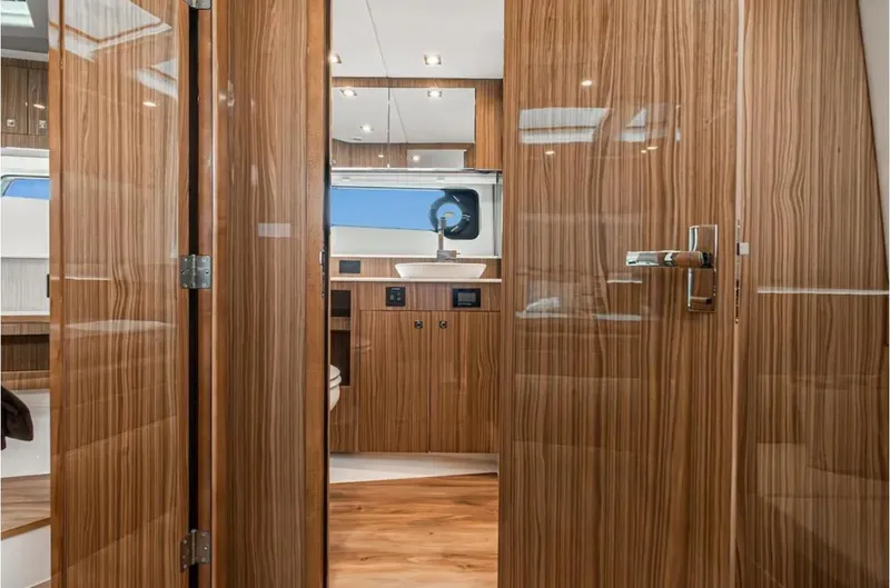 Slide: The Image of Luxurious interior of 2025 Cruisers Yachts 50 GLS with sleek wood finish. - 36